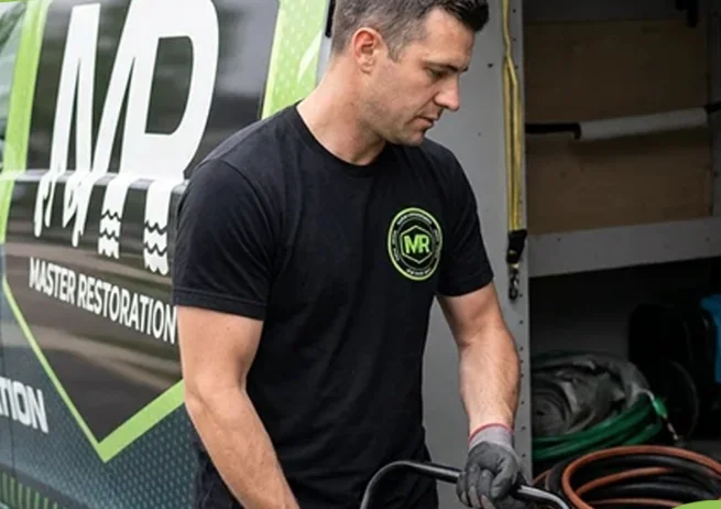 Master Restoration technician preparing equipment at the service van
